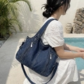 Deep blue denim tote bag with multiple zipper pockets and adjustable shoulder strap - Dark Blue