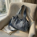 Retro washed blue denim tote bag with adjustable strap on a cozy beige armchair - Light Blue