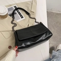 Minimalist black quilted leather crossbody bag with metal chain strap and grid stitching - Black