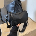 Minimalist black cylinder shoulder bag with wide strap and sleek matte finish - Smooth Black