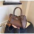 Detail of dark brown lychee textured tote bag with silver metal twist lock and bead charm - Coffee with Pendant