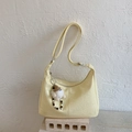 Détail du sac bandoulière plissé jaune clair en similicuir avec pendentif en peluche - Jaune