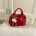 Close-up of bright red vintage Boston bag featuring a plush dog charm and pearl beads - Red with Pendant