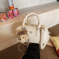 Chic white Boston handbag made of PU leather with bear charm on stone steps - With Charm / Off White