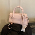 Elegant light pink shiny leather handbag with double strap buckles and shoulder strap - Pink