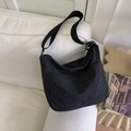 Detail of black plaid canvas crossbody bag featuring adjustable strap and side pocket - Black