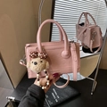 Pink glossy faux leather crossbody bag with bear pendant and embossed heart pattern - With Charm / Pink