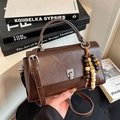 Retro dark brown leather handbag with wooden bead tassel and silver metal buckle - Brown