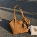 Brown faux suede tote bag with long handles and a cute bear charm on a city street - With Charm / Brown