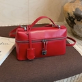 Minimalist red leather pillow bag with silver zippers and a sleek metal padlock decoration - Red