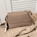 Minimalist khaki crossbody bag with lychee texture and beaded tassel charm detail - Khaki with Pendant