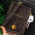 Nahaufnahme der braunen Leder-Handytasche mit weißen Nähten und Plüschtier-Anhänger - Kaffee Mit Anhänger