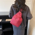 Bolso de pecho multifuncional de nailon rojo rosa mostrado en un modelo de forma casual - Burdeos