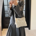 Handmade cream woven crossbody bag with fringe detail and braided strap for beach vacations - White