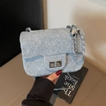 Light blue quilted denim crossbody bag with silver chain strap and metal lock closure - Blue