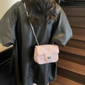 Elegant light pink quilted shoulder bag with metal chain strap shown on a female model - Pink