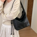 Minimalist black faux leather hobo bag with drawstring knots and matte lychee texture - Black