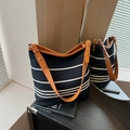 Striped navy canvas bucket bag with brown leather straps and adjustable silver buckles - Blue