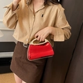 Fashionable red acrylic mirror box bag with metal handle shown on a model - Red