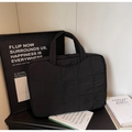 Detail of black quilted nylon laptop bag featuring reinforced handle and waterproof texture - Black