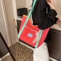 Vibrant red nylon mesh tote bag with green straps and colorful hanging ornament - With Pendant / Red