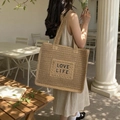 Straw tote bag featuring LOVE LIFE embroidery and dual handles for beach vacation - Khaki