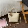 Chic off-white lychee pattern bucket handbag with crossbody strap and wooden horse pendant - Cream Apricot