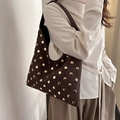 Retro dark brown hobo bag with gold studs on suede texture shown on a model - Brown