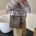 Dark brown pebble leather tote bag with elegant buckle detail and crossbody strap - Brown