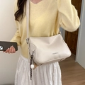 Chic cream-colored crossbody bag with wide strap and creative baseball charm detail - White