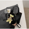 Detail of black lychee grain leather bucket bag with gold lock and dog plush charm - With Pendant / Black