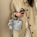 Light blue bucket bag with decorative knot handle and cute brown bear charm accessory - Light Blue