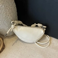 Minimalist creamy white half-moon crossbody bag with decorative knotted strap and metal tips - Off White