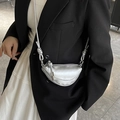 Mini silver saddle bag with metallic finish and thick rope shoulder strap worn by model - Silver