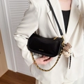 Black leather baguette shoulder bag with gold chain and plush puppy charm - Black