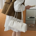 Minimalist creamy white faux leather tote bag shown on model for stylish casual look - White
