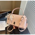 Close-up of pink faux leather bag with silver metal lock, pearl chain, and lace bow detail - With Pendant / Pink