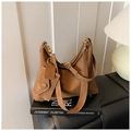 Detailed close-up of brown suede hobo bag featuring white contrast stitching and gold buckle - Brown