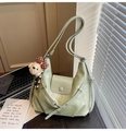 Close-up of light green PU leather hobo bag with a cute bear pendant and flap button - Green with Pendant