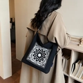 Black canvas tote bag with white floral mandala embroidery and single shoulder strap - Black