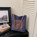 Blue canvas tote bag with orange floral embroidery and brown leather handles - Blue