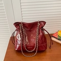 Sac seau bordeaux matelassé avec bandoulière chaîne dorée et cuir synthétique poli - Rouge