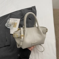 Elegante beige Lederhandtasche mit Lychee-Maserung, verstellbarem Gurt und Goldakzenten - Grau