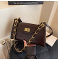 Details einer dunkelbraunen Lackleder-Schultertasche mit Goldkette und Drehverschluss - Braun