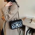 Classic black quilted shoulder bag with gold chain strap and glossy finish in style - Black