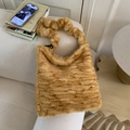 Detailopname van de pluizige bruine tijgerstreep pluche tas op een bank met gezellige decor - Tijger Geel