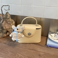Creamy crossbody box bag with silver twist lock and cute teddy bear charm detail - Yellow with Pendant