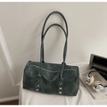 Detailed view of dark green tote with silver rivets and zipper on lifestyle background - Blue
