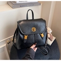 Detail of black faux leather backpack featuring golden twist lock and cute bear plush charm - Black with Pendant