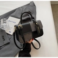 Detail of minimalist contrast patchwork handbag with wool fabric and leather texture - Large / Black